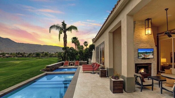 A poolside area with a fire pit and outdoor seating.