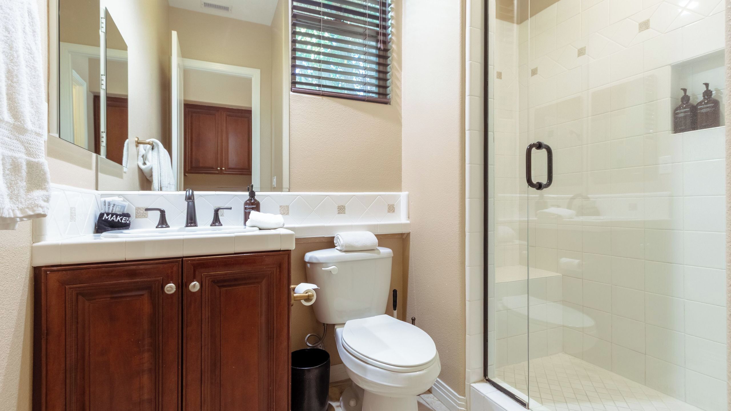 A bathroom with a shower, toilet, and vanity.