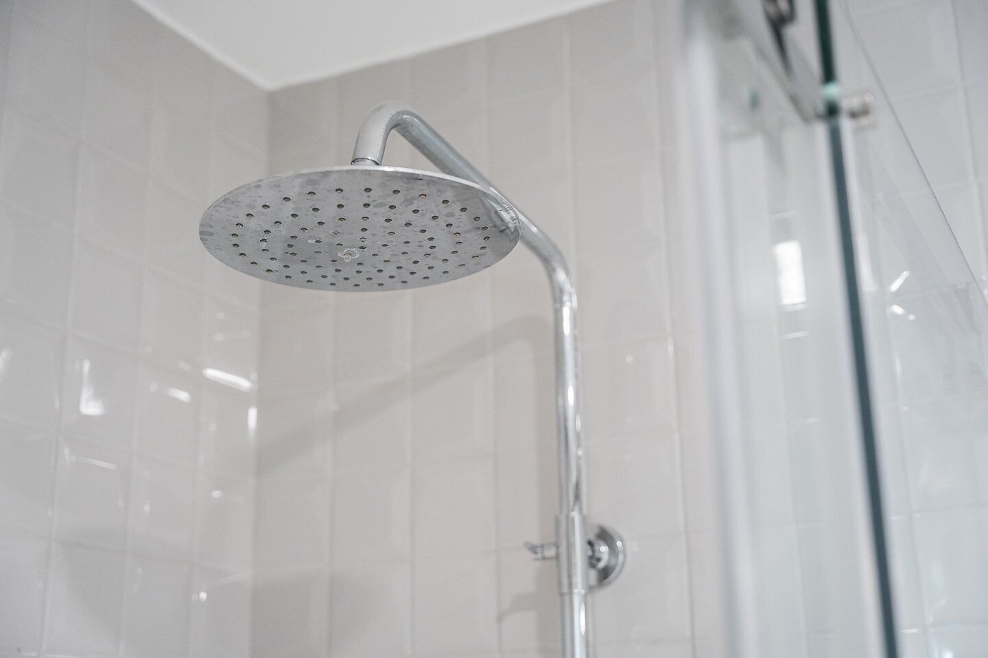 A showerhead with a curved design and a single handle.