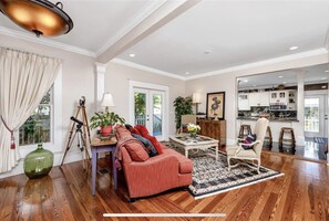 Relax in this spacious living area with a comfortable sofa, coffee table, and side table, perfect for unwinding with a good view.