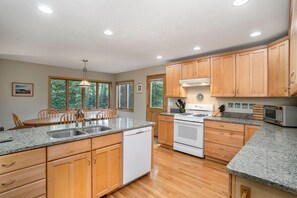 Enjoy cooking in this well-equipped kitchen with a dishwasher, gas range, and stainless steel sink.