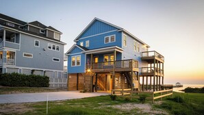 A two-story beachfront house with a balcony, a deck, and a view of the ocean. - Waterfront Home with Panoramic Views in Black Dog Harbor, Salvo, NC  (Salvo)