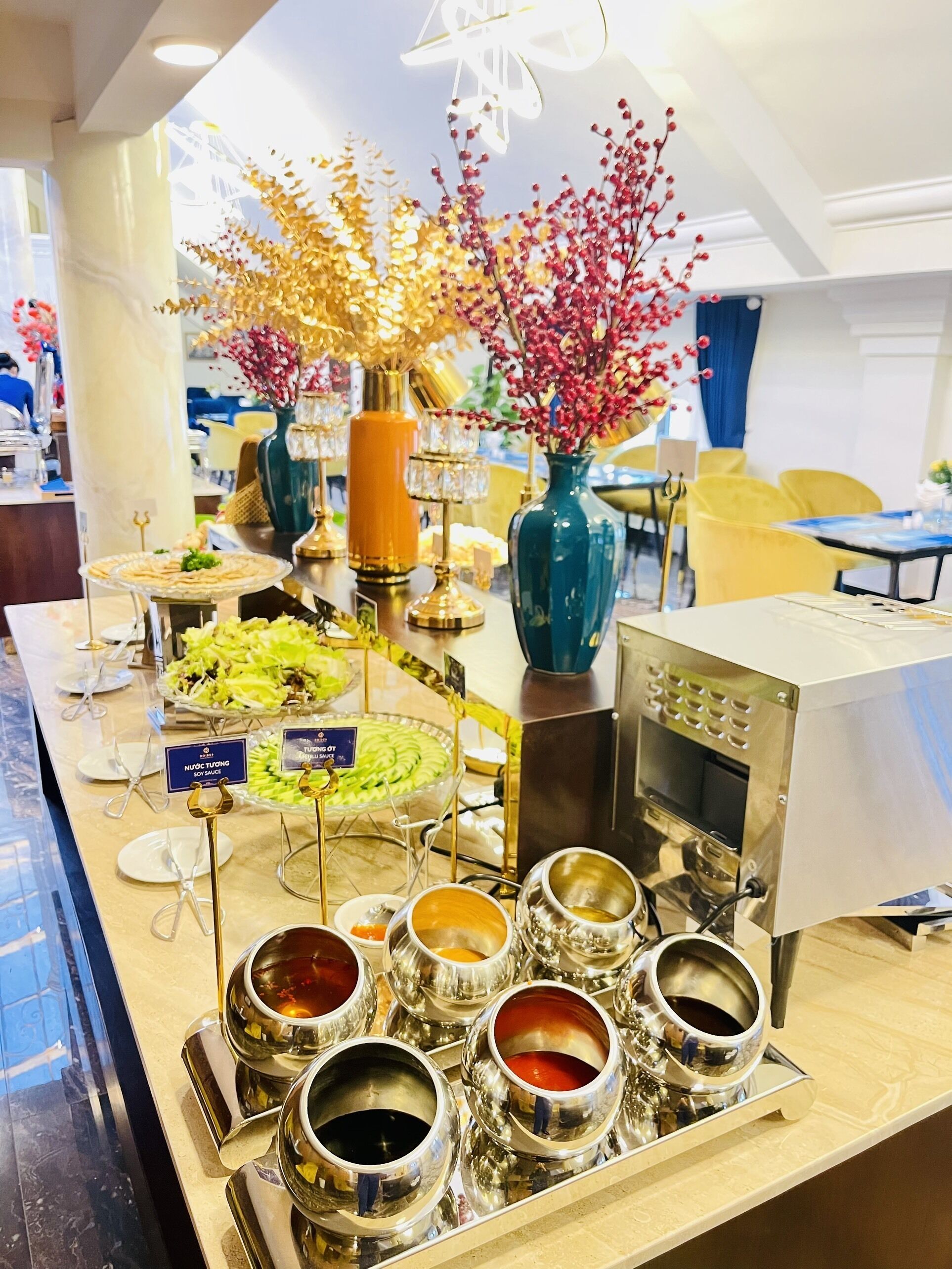 A buffet setup with various food items and condiments.