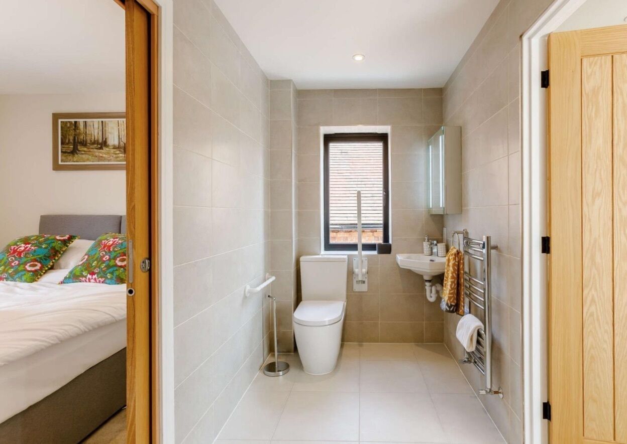 A compact bathroom with a toilet, sink, and window.