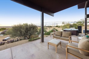 A covered outdoor seating area with a view of the desert landscape. - Jackalope Junction-Hot Tub Fire Pit BBQ Views (Pioneertown)