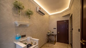 A hotel bathroom with a vanity, a mirror, a shower area, and a door. - ACJ Residence - A Member of The Luxury Stay Group (Kota Kinabalu)