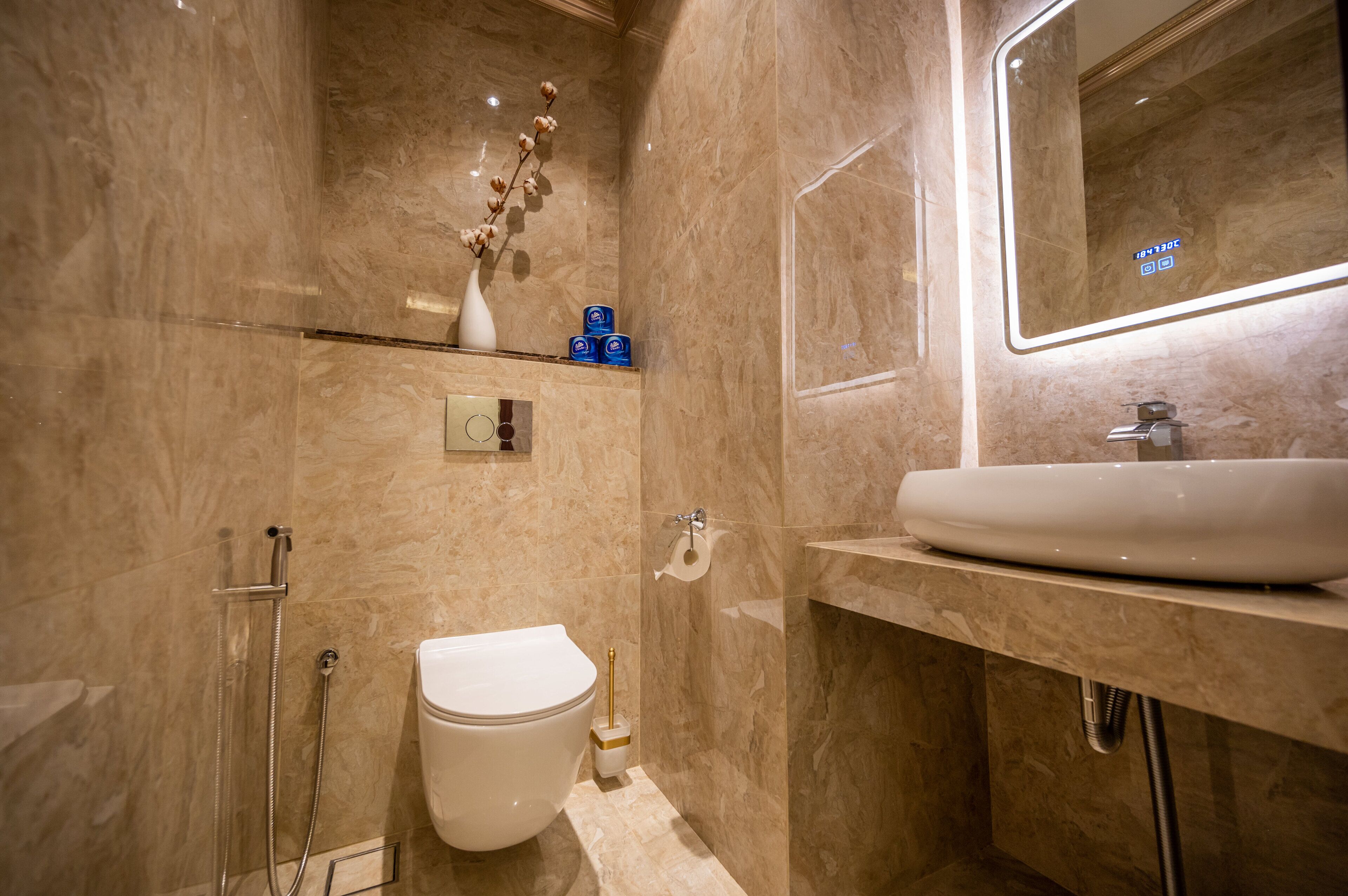 A modern bathroom with a toilet, bidet, and sink.