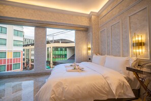 A hotel room with a large bed, a view of the cityscape, and a modern design. - ACJ Residence - A Member of The Luxury Stay Group (Kota Kinabalu)