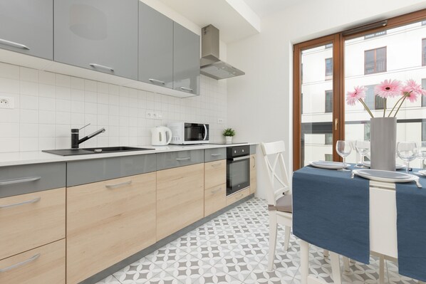 Apartment, 1 Bedroom, Kitchen | Private kitchen | Microwave, dishwasher, electric kettle, highchair - Apartment Sierakowskiego by Renters (Warsaw)