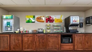 A breakfast bar with a refrigerator, coffee maker, and microwave. - Quality Inn Creston (Creston)