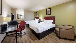 A hotel room with two beds, a desk, a chair, and a small sofa. - Baymont by Wyndham El Dorado (El Dorado)