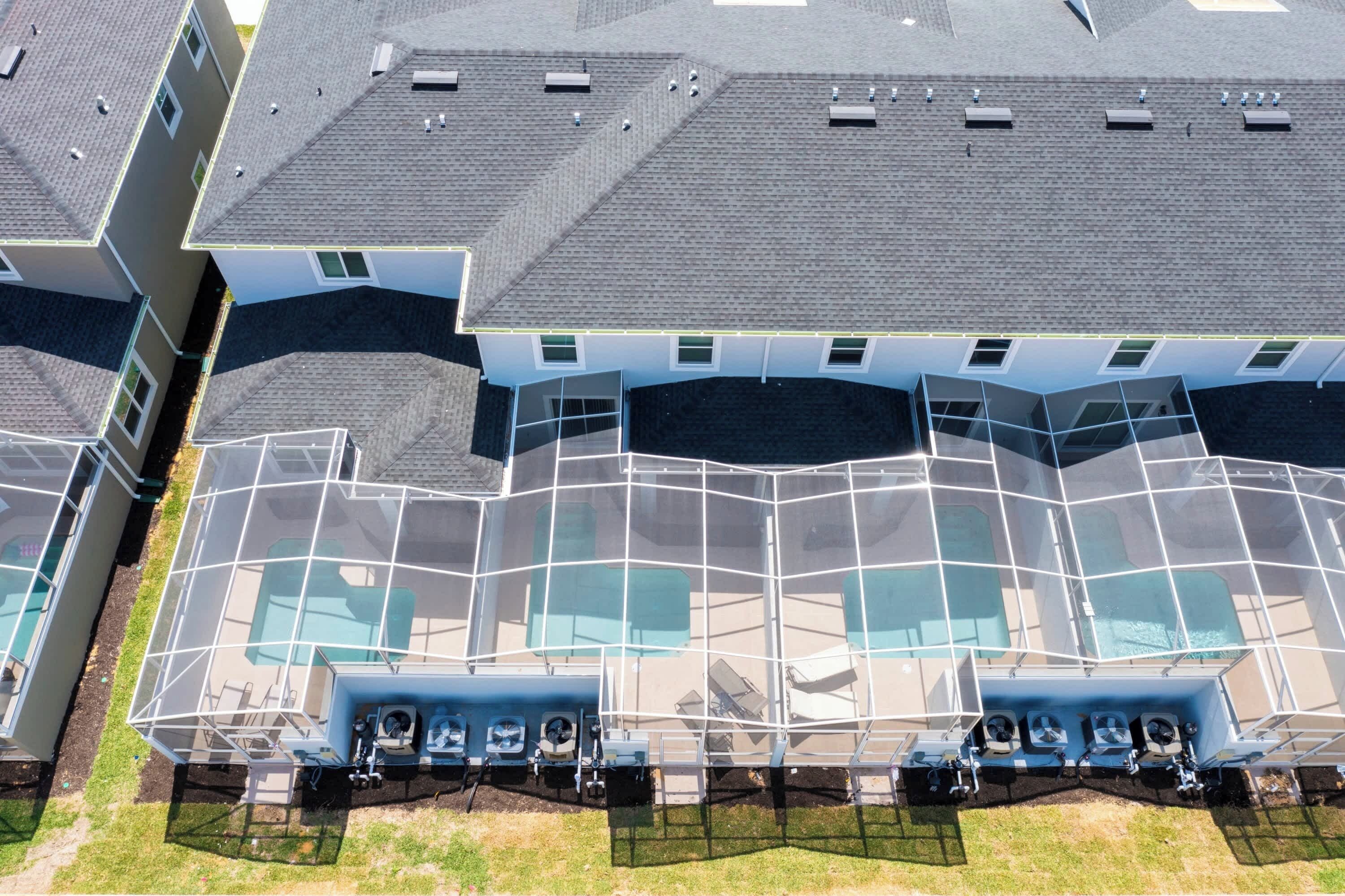 A modern building with a unique angular design, featuring multiple levels and large glass windows.
