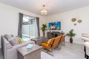 Townhome | Living area | 60-inch Smart TV with cable channels, Netflix, Hulu - Gorgeous Decor 4 Bd w/ Pool Close to Disney 4820 (Kissimmee)