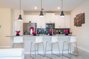 Townhome | Private kitchen | Full-size fridge, microwave, oven, stovetop