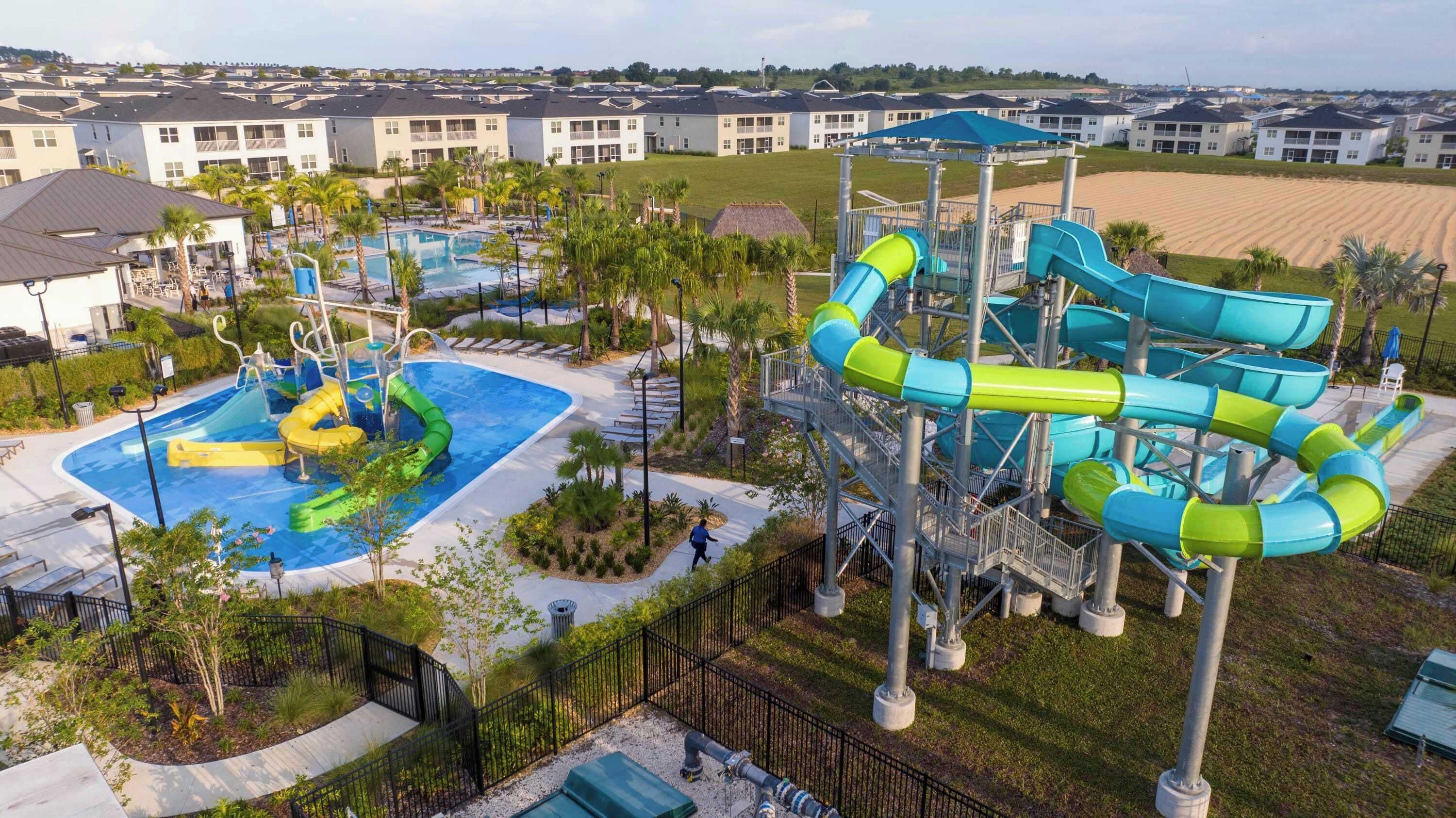 A water park with multiple slides and a pool, surrounded by residential buildings.