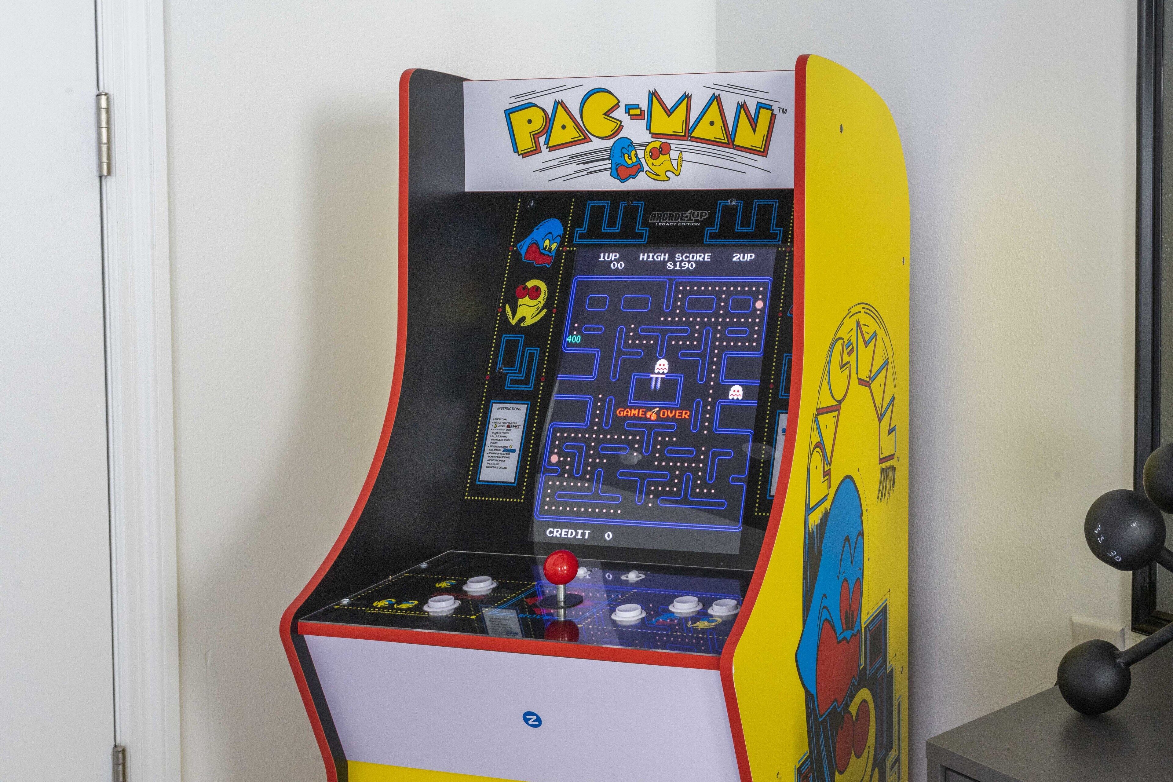 A Pac-Man arcade machine with a score display and joystick.