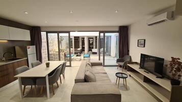 Superior Apartment | Living area | 43-inch Smart TV with satellite channels, TV
