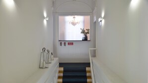 A staircase with a dark blue carpet leading to a door with a sign reading "BOCA DE INCENDIO". - Two-Bedroom Family Ap in Bolhão Market (Oporto)