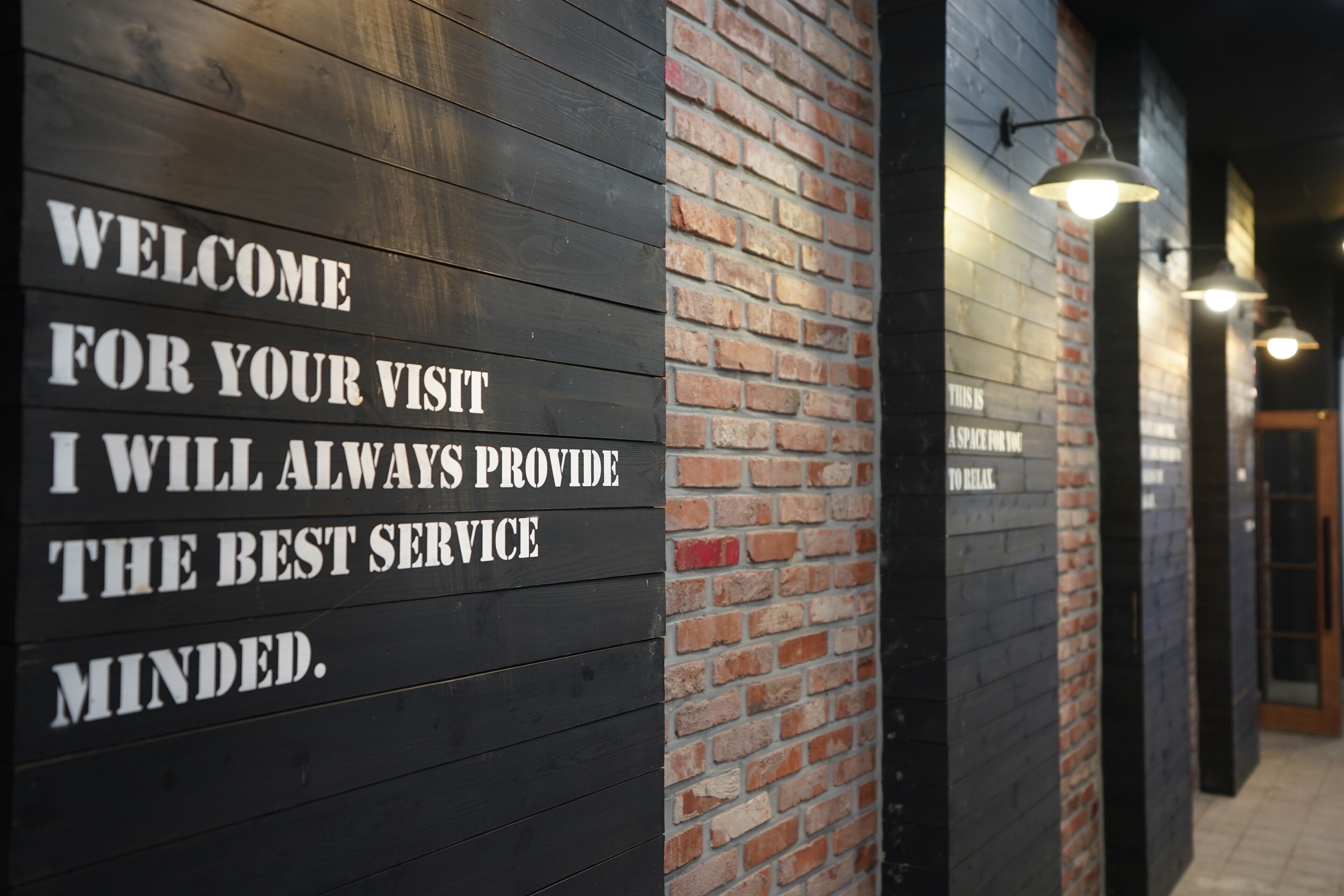A wall with a welcoming message for visitors.