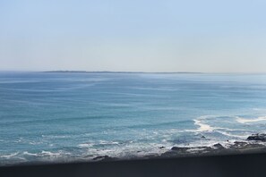 A coastal view with calm sea and distant land. - Blouberg Heights 1601 by HostAgents (Cape Town)