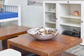 A wooden dining table with a bowl of dried mushrooms in the center.