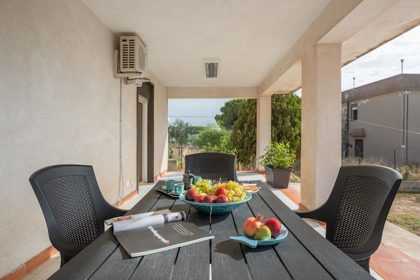 Une table avec un saladier de fruits, un magazine et une tasse.