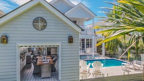 A house with a deck, a pool, and outdoor seating. - The Jasmine Gate (Casuarina)