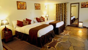 A hotel room with two beds, a stone floor, and a mirror. - Da Vinci Gorilla Lodge (Muhoza)