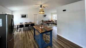 A modern kitchen with a wooden dining table, a built-in refrigerator, and a ceiling fan. - Wild Stallion Retreat Close to Sedona (Cottonwood)