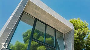 A modern building with a large glass window and a geometric facade. - Villa ALEX by Abahana Villas (Benissa)
