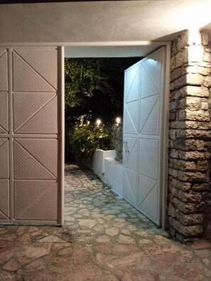 Stroll through the entrance, marked by a rustic stone pathway and a beautifully designed gate.