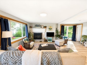 A living room with a fireplace, television, and seating area.