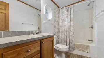 Bathtub, towels, soap, toilet paper