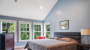 A bedroom with a bed, dresser, and a painting on the wall. - Destined for Relaxation (Saugatuck)