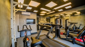 A gym with treadmills, stationary bikes, and weight machines.