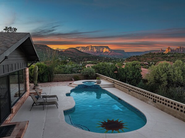 Relax by the sun-shaped pool surrounded by a modern structure and take in the breathtaking views of the surrounding mountains.