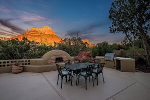 Enjoy al fresco dining on the patio surrounded by lush vegetation and breathtaking mountain views.