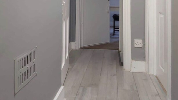A narrow hallway with a door at the end leading to another room. - Orpington RSG House (Orpington)