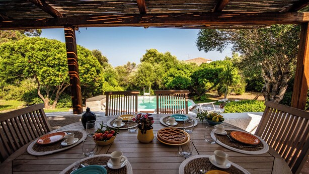 An outdoor dining area with a view of a swimming pool and trees. - Villa Isa 6, Emma Villas (Altura)