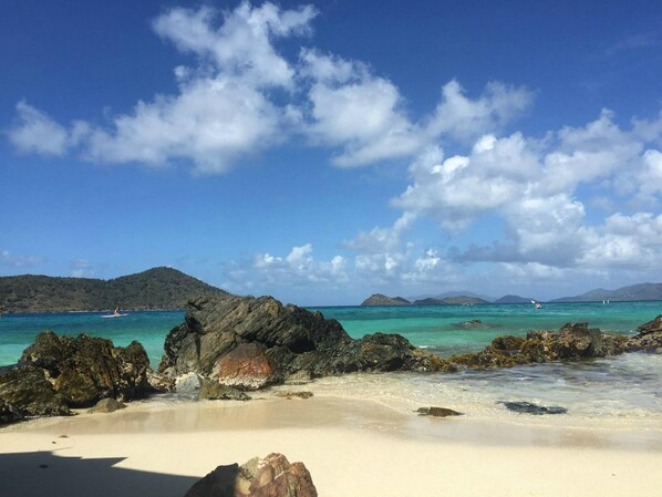 A beach with clear turquoise water, rocky outcrops, and distant mountains under a partly cloudy sky. - 1BR/1BA w/Amazing Views-Perfect Location! Private & Intimate Sea LaVie (Charlotte Amalie)