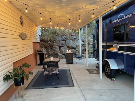 Outdoor dining. Charming Winnie Drop Trailer with Cozy Private Patio Escape