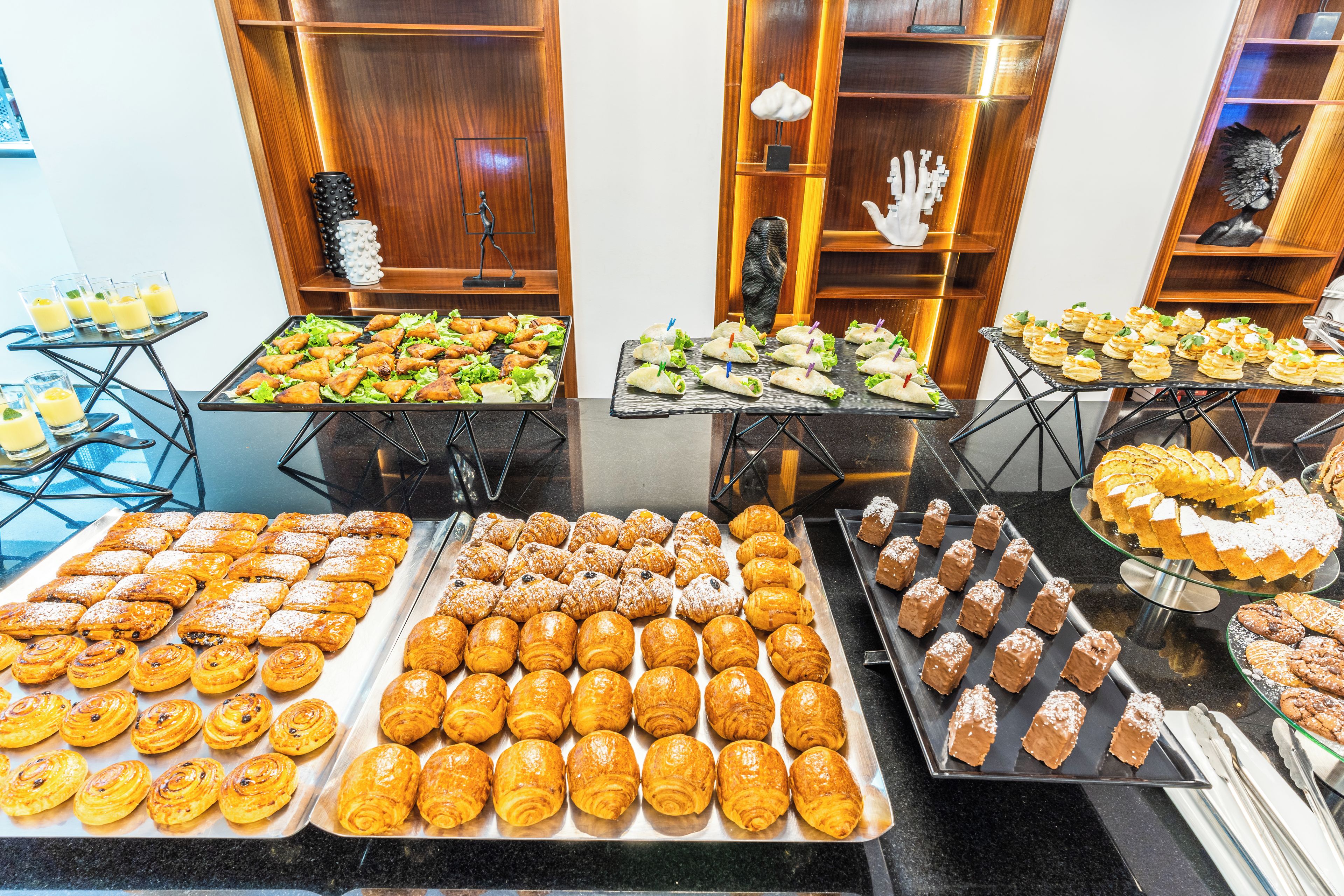 A buffet with various pastries and desserts.