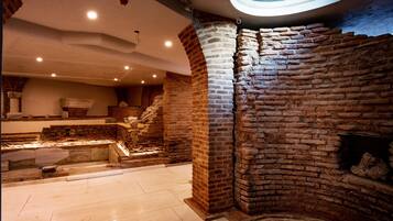 Experience a warm and rustic ambiance in this cozy space with exposed brick walls and a vaulted ceiling.