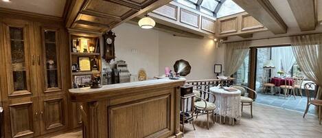 A spacious kitchen with wooden cabinetry, a central island, and a dining area with a table and chairs.
