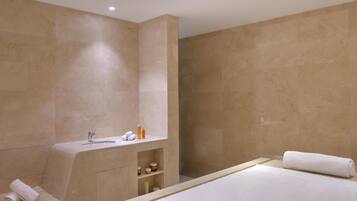 A modern bathroom with a bathtub, a sink, and a shower area.