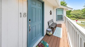 A porch with a blue door, a bench, a colorful pot, and a stop sign in the background. - ☀️350yd2Beach-Patio-Bikes-Firepit-30A-Dunestruck☀️ (Santa Rosa Beach)