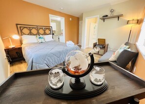 A hotel room with a bed, bedside table, lamp, globe, and a mirror. - Mad Men Retro Style w/ Record Player (Salem)
