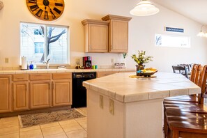 Enjoy cooking in this well-equipped kitchen with a large island, sink, and ample counter space.