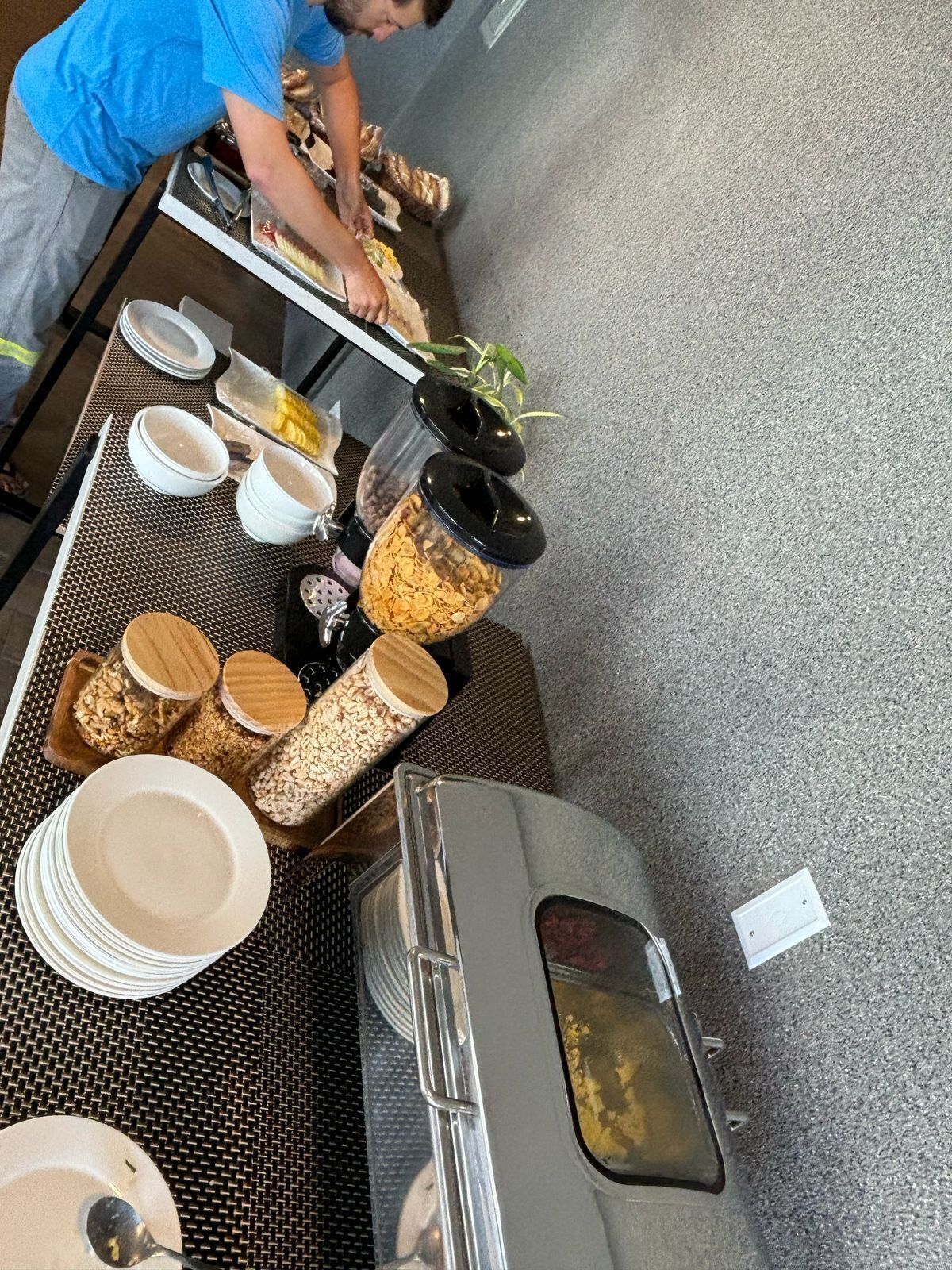 A buffet setup with various food items and containers.
