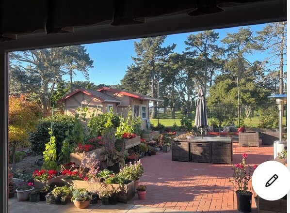 Enjoy a serene garden oasis with a seating area and lush greenery.